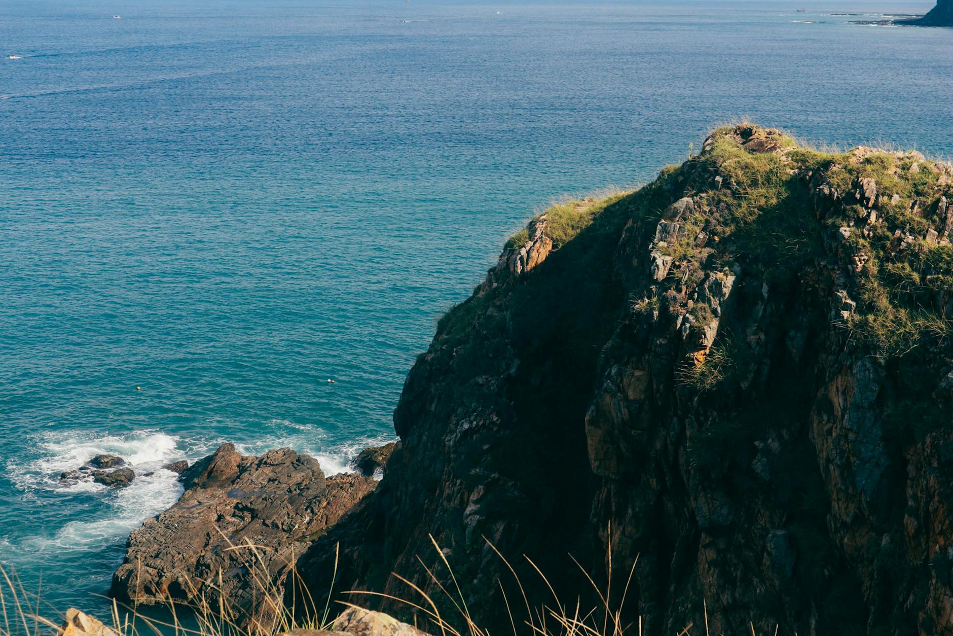 scenic rocky cliff overlooking blue ocean